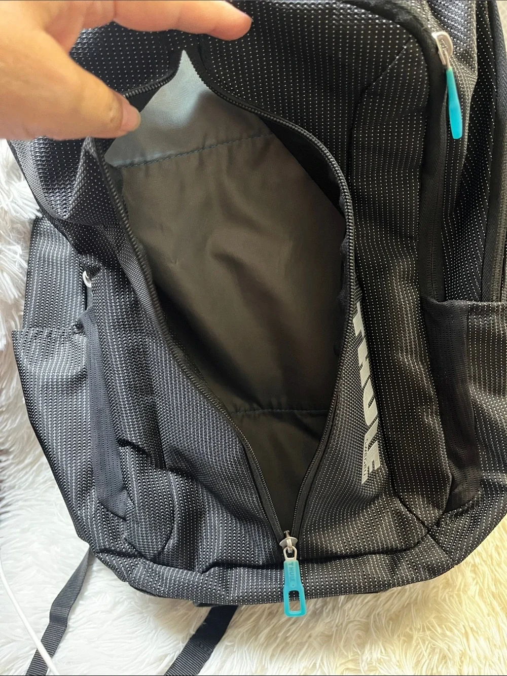 Thule Black Backpack with Teal Zipper Accents